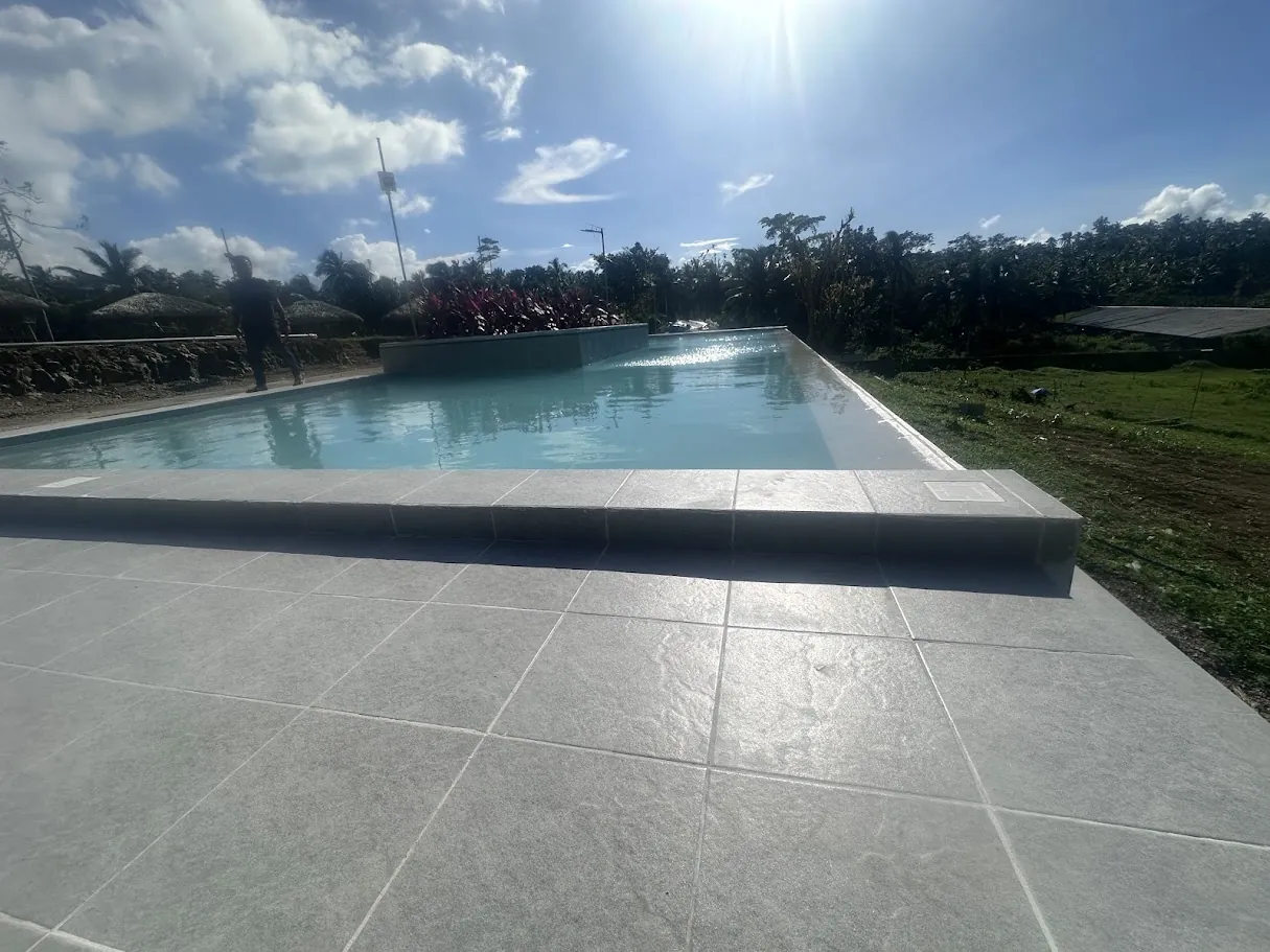 60sqm INFINITY Type swimming pool (non heated). With 2.5m x 2.5m sunken Garden and 44sqm tiled deck